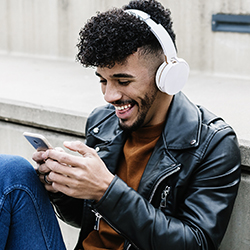 Student on phone with headphones